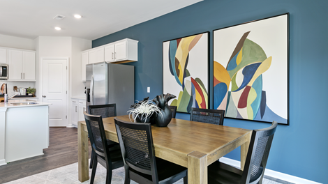 formal dining room featuring a teal accent wall and wooden table with chairs