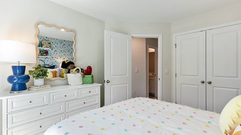 bedroom featuring childs decor and a large window