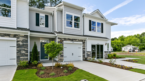Front exterior of a Denver floorplan home featuring white and grey siding with stone accents