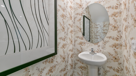 powder bathroom featuring floral wallpaper
