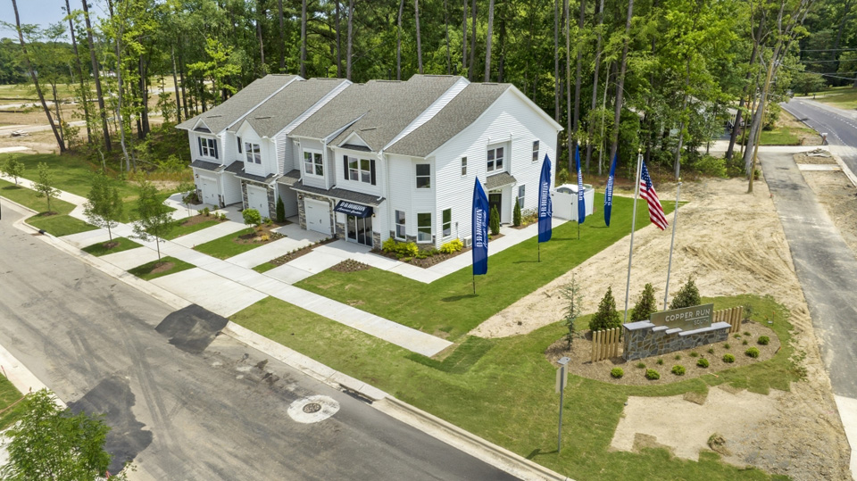 side exterior view of townhomes featuring the community monument