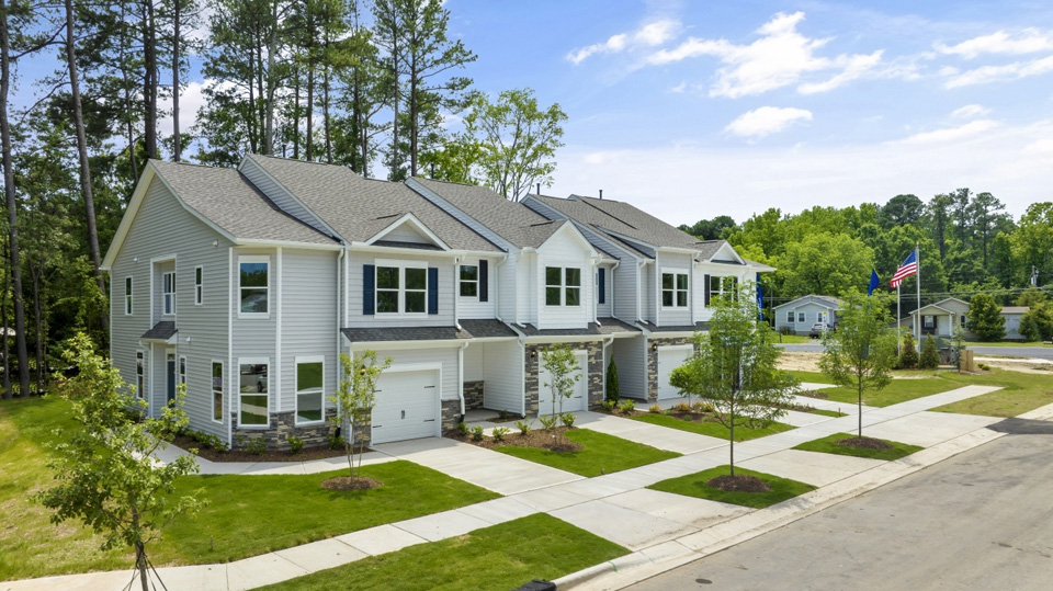 side exterior view of townhomes featuring sidewalk access to homes