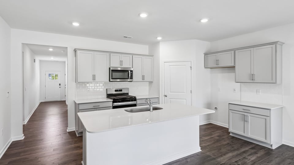 kitchen with island white cabinets and quartz countertops