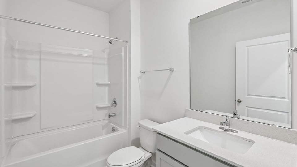 bathroom with quartz countertops and tub shower combo