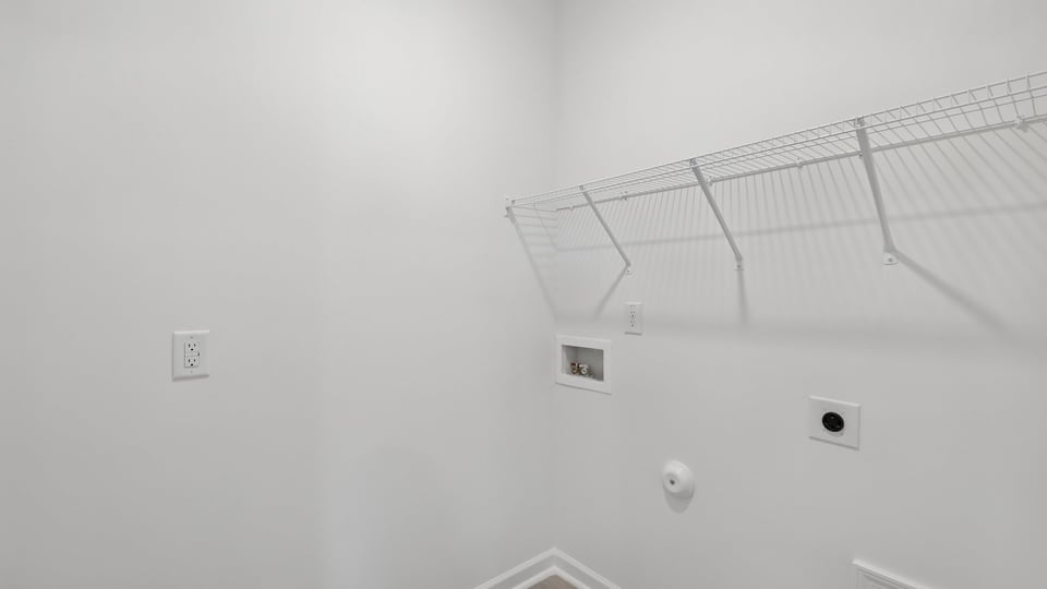 laundry room with washer and dryer shelving