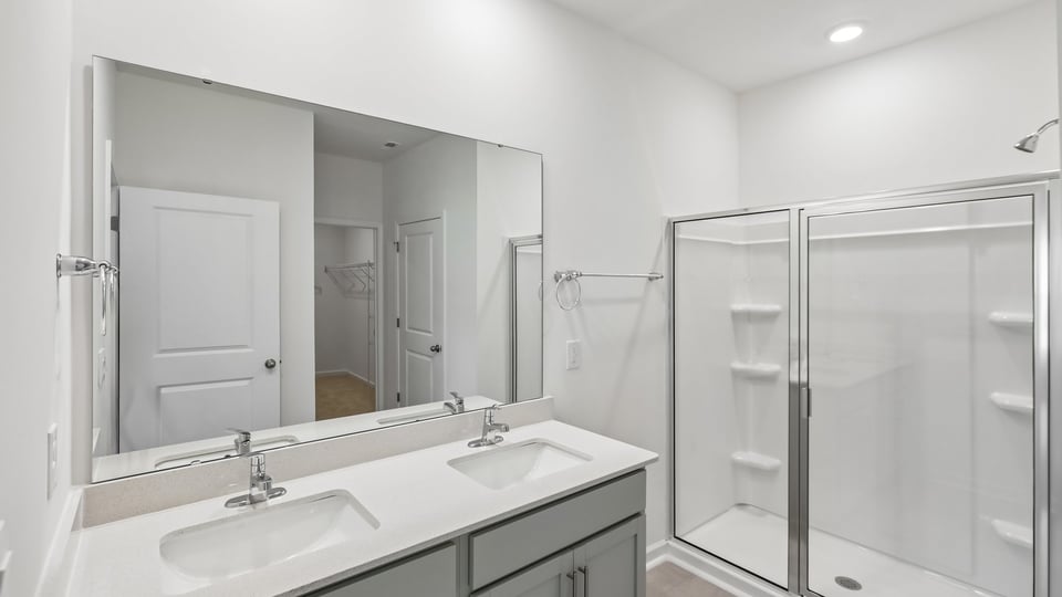bathroom with walkin shower and quartz countertops