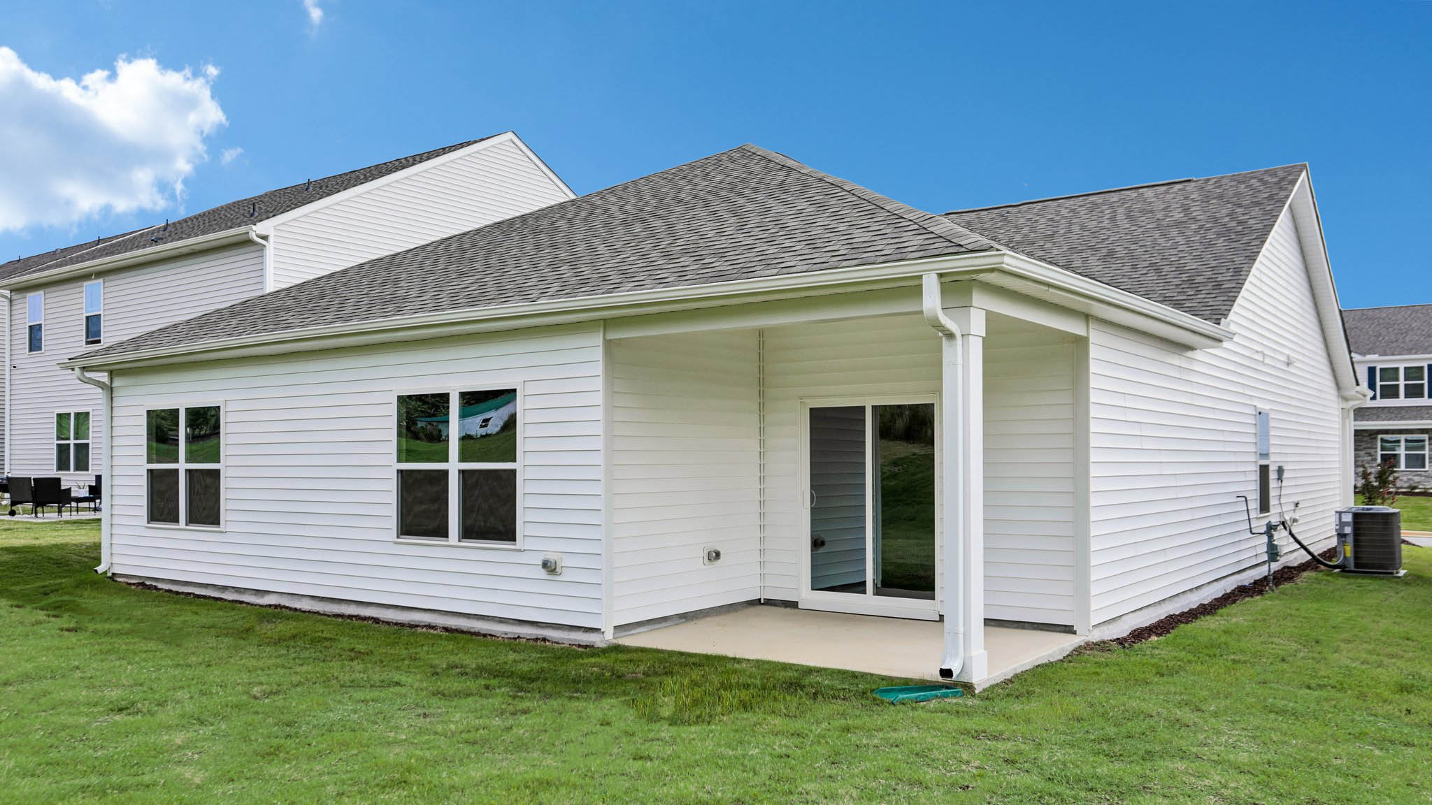 back of home with covered concrete patio