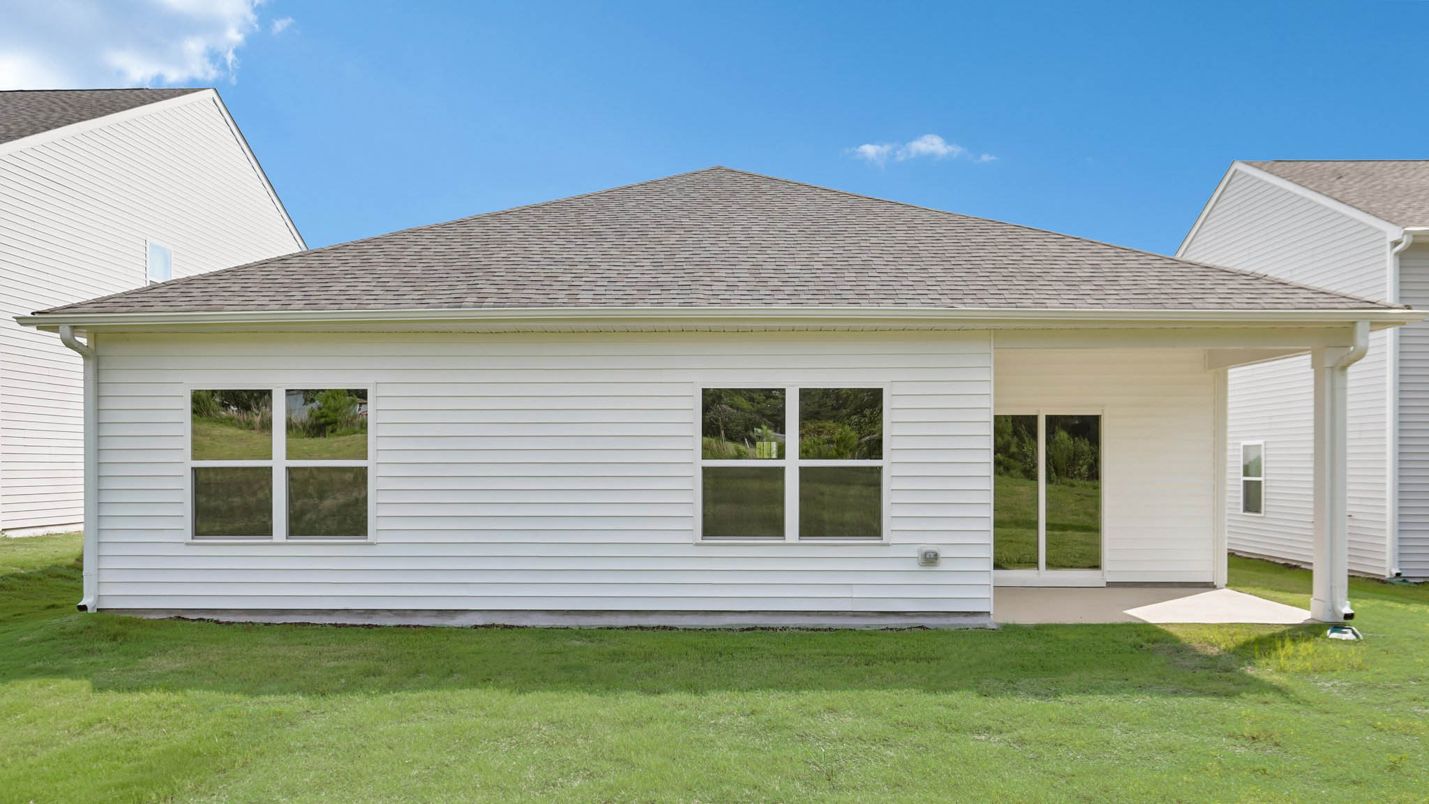 back of home with covered concrete patio