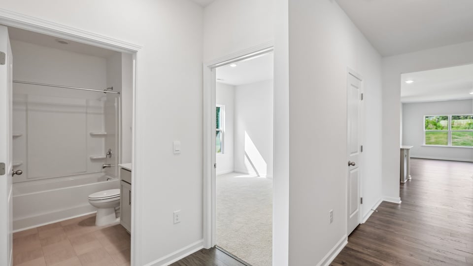 entryway with bedroom and laundry room on left