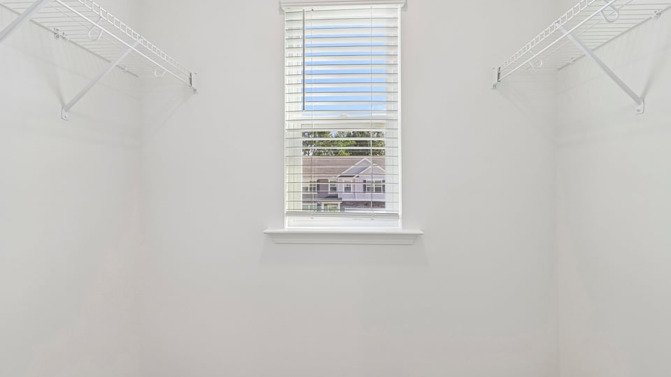 walkin closet with wire shelving and window