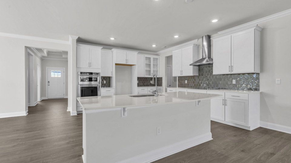 kitchen with white cabinets quartz countertops and spacious kitchen island