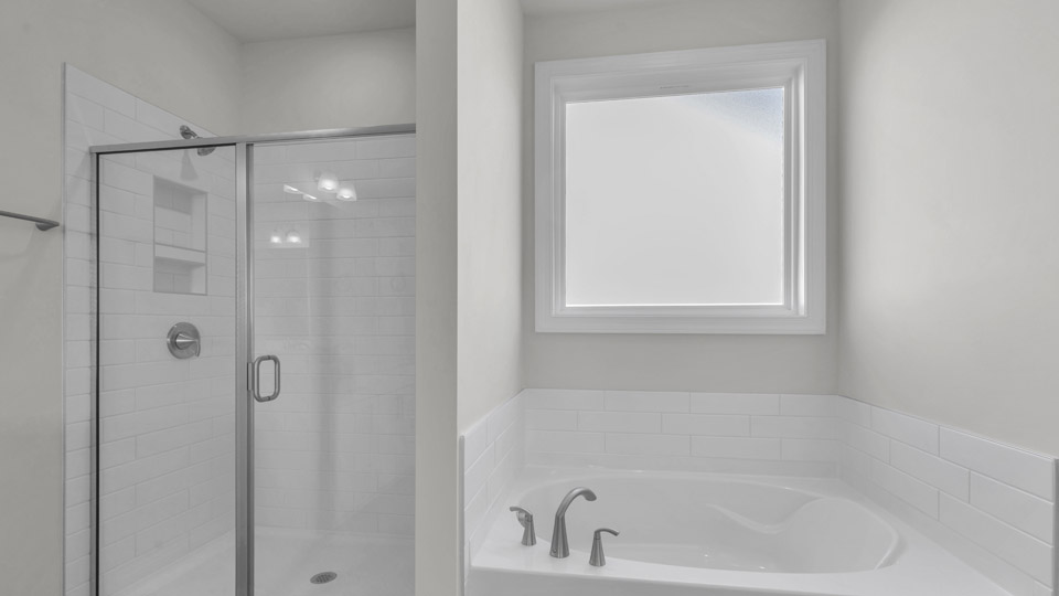 bathroom with separate tub and walkin shower with glass doors