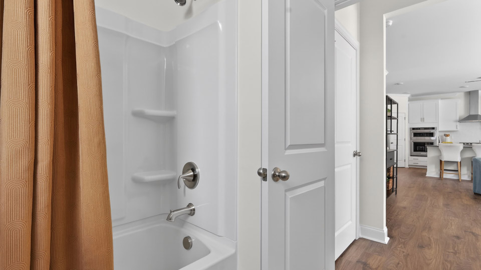 secondary bathroom with shower tub combo and single vanity sink