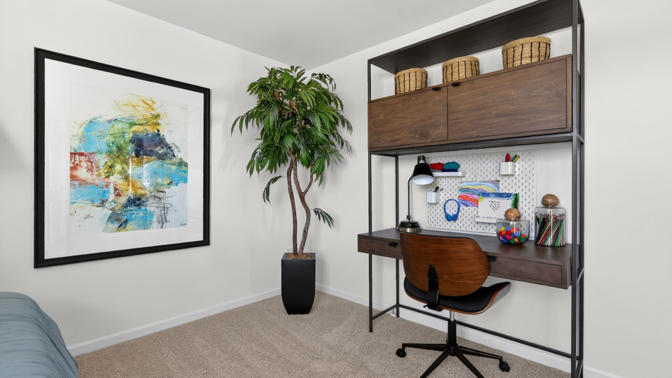 upstairs loft area with large windows and carpeting