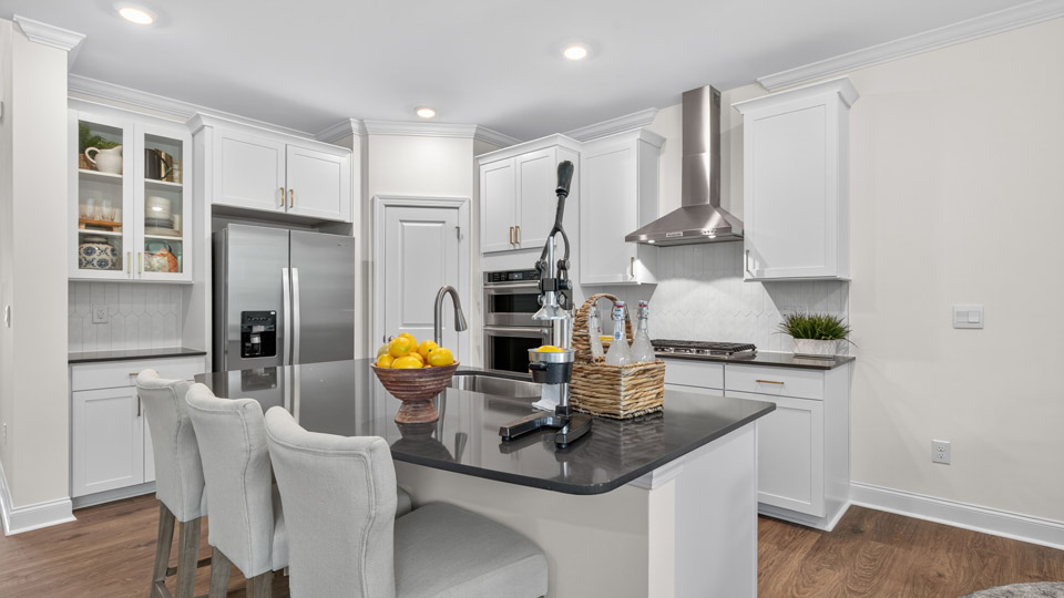 kitchen with white cabinets quartz countertops and stainless steel appliances