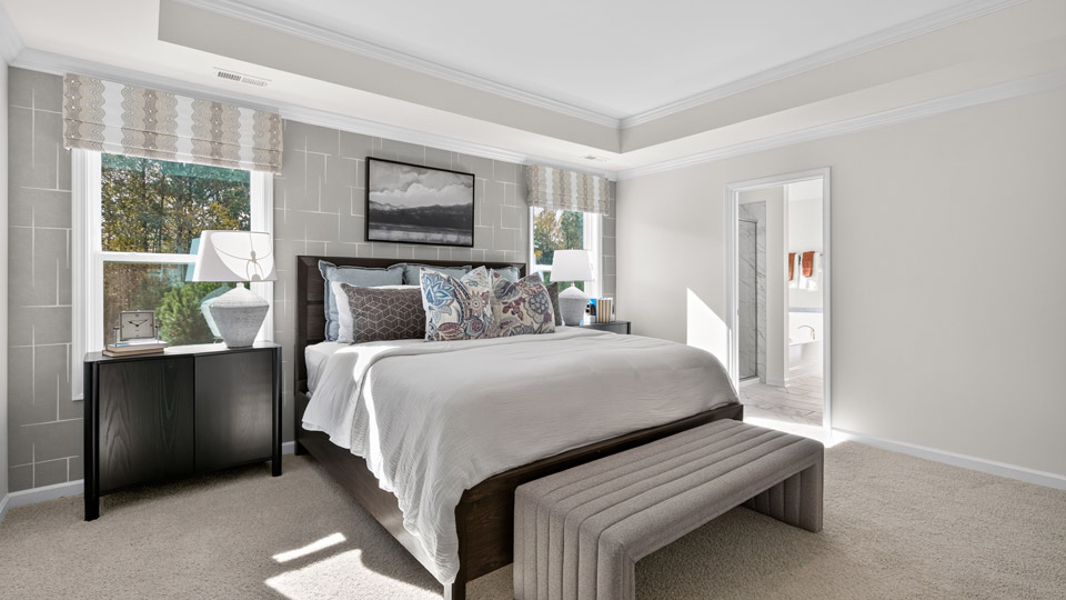 bedroom with carpet flooring and tray ceiling