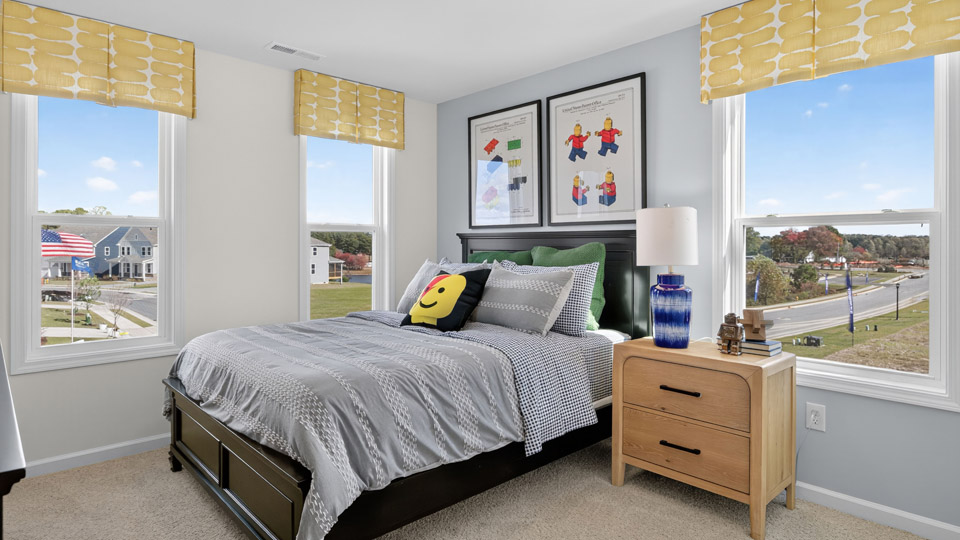 bedroom with carpet flooring and lots of natural lighting