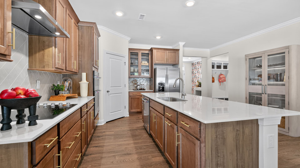 kitchen with quartz counters, kitchen island, pantry, stainless steel appliances