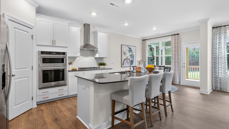 kitchen with white cabinets quartz countertops ceramic tile backsplash and kitchen island