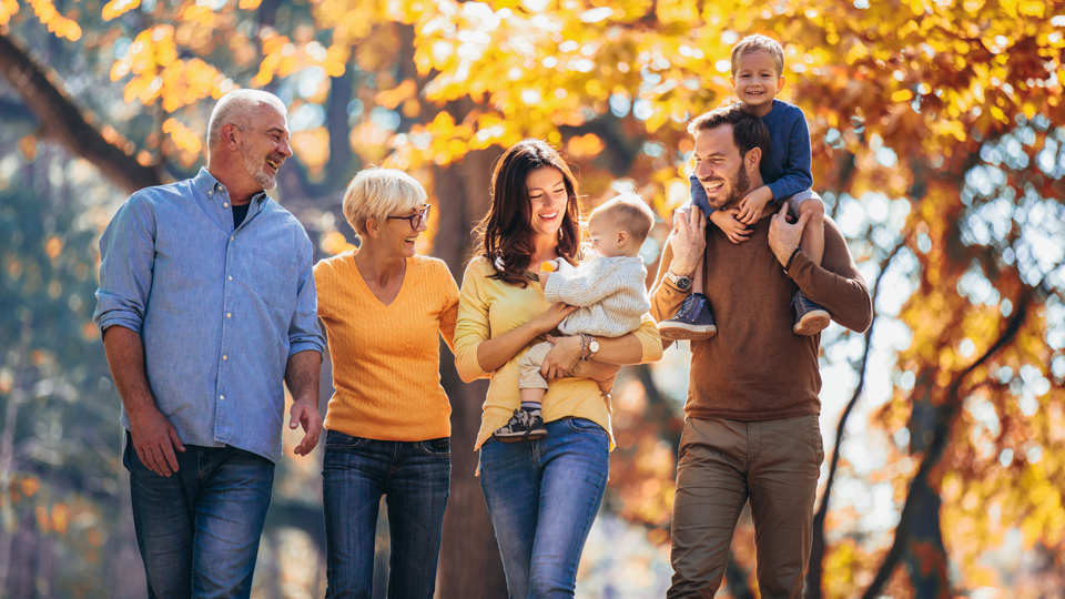 multigenerational family laughing taking a walk outside