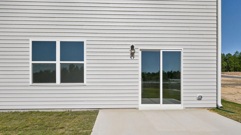 exterior patio with concrete slab and open yard