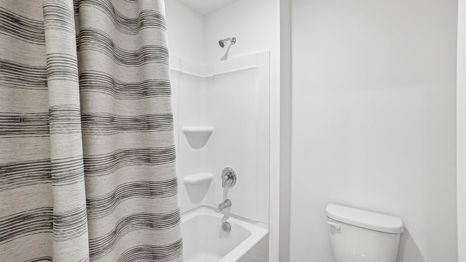 secondary bathroom with shower tub combo and single vanity sink