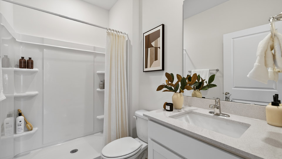 secondary bathroom with shower tub combo and single vanity sink