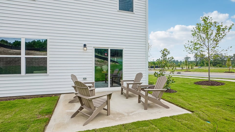 exterior patio with concrete slab and open yard