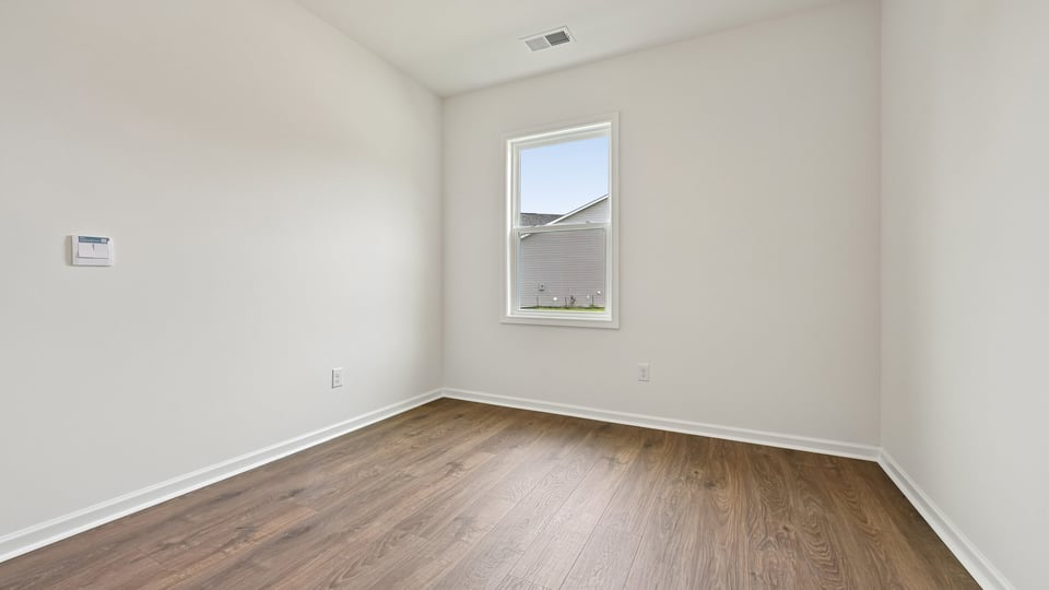 additional bedroom with revwood flooring