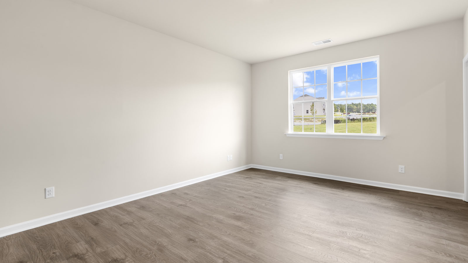 primary bedroom with two windows and revwood, attached bath