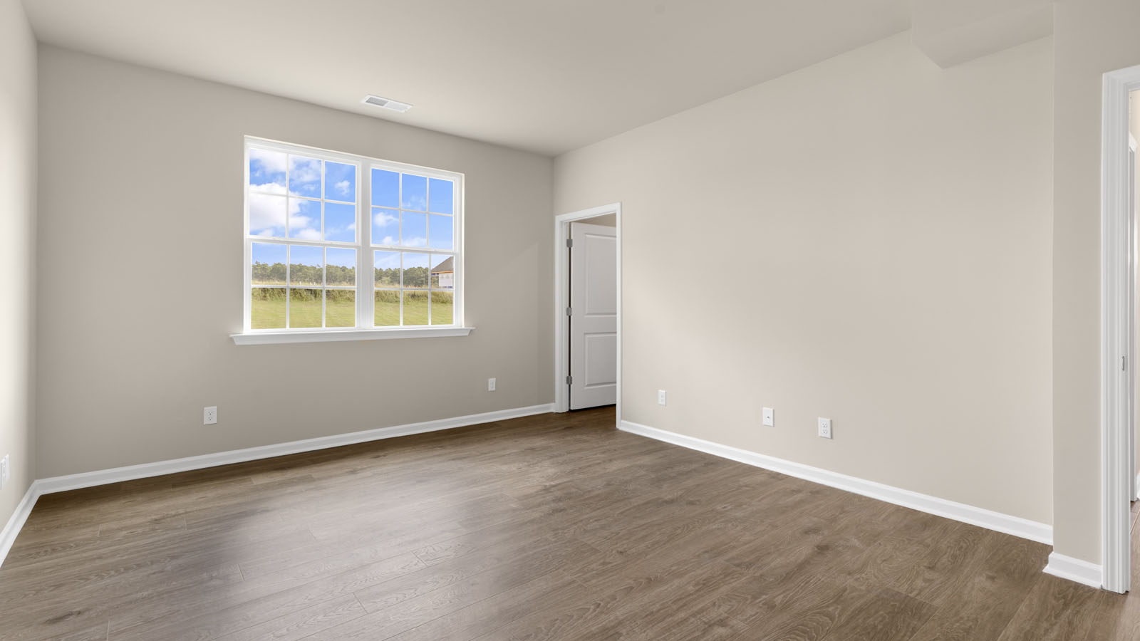 primary bedroom with two windows and revwood, attached bath