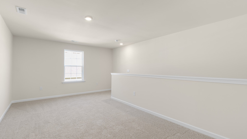 upstairs loft area with large windows and carpeting