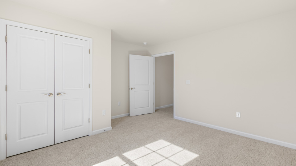secondary bedroom with window and closet, carpeting