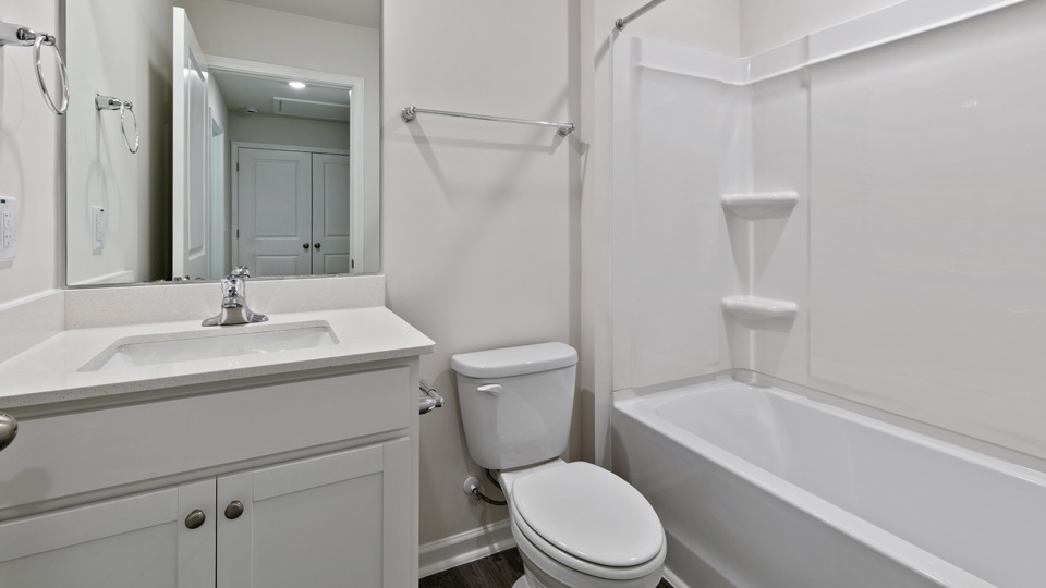 secondary bathroom with shower tub combo and single vanity sink