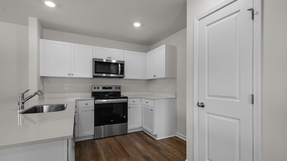 Kitchen with white cabinets and stainless steel appliances.