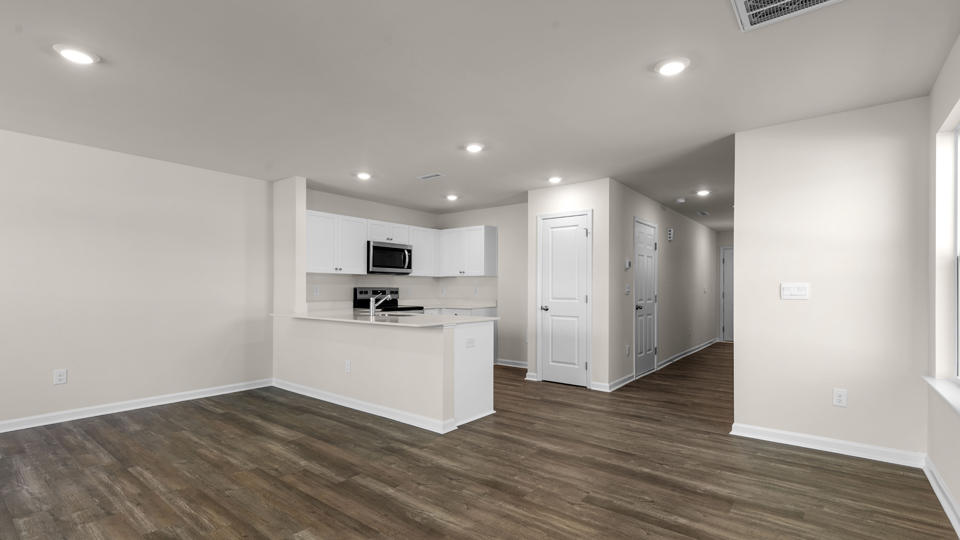 Open concept living room leading to kitchen