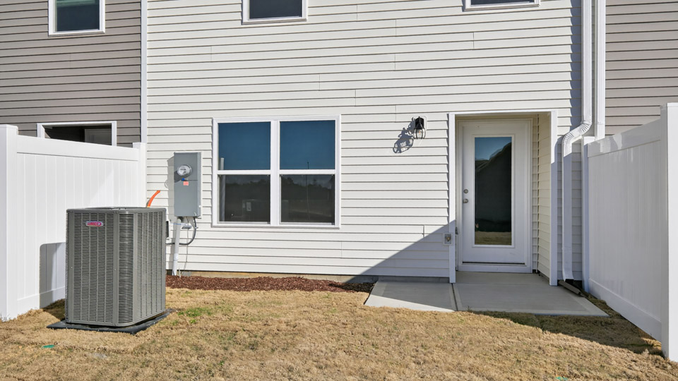 Two story town home with white siding.