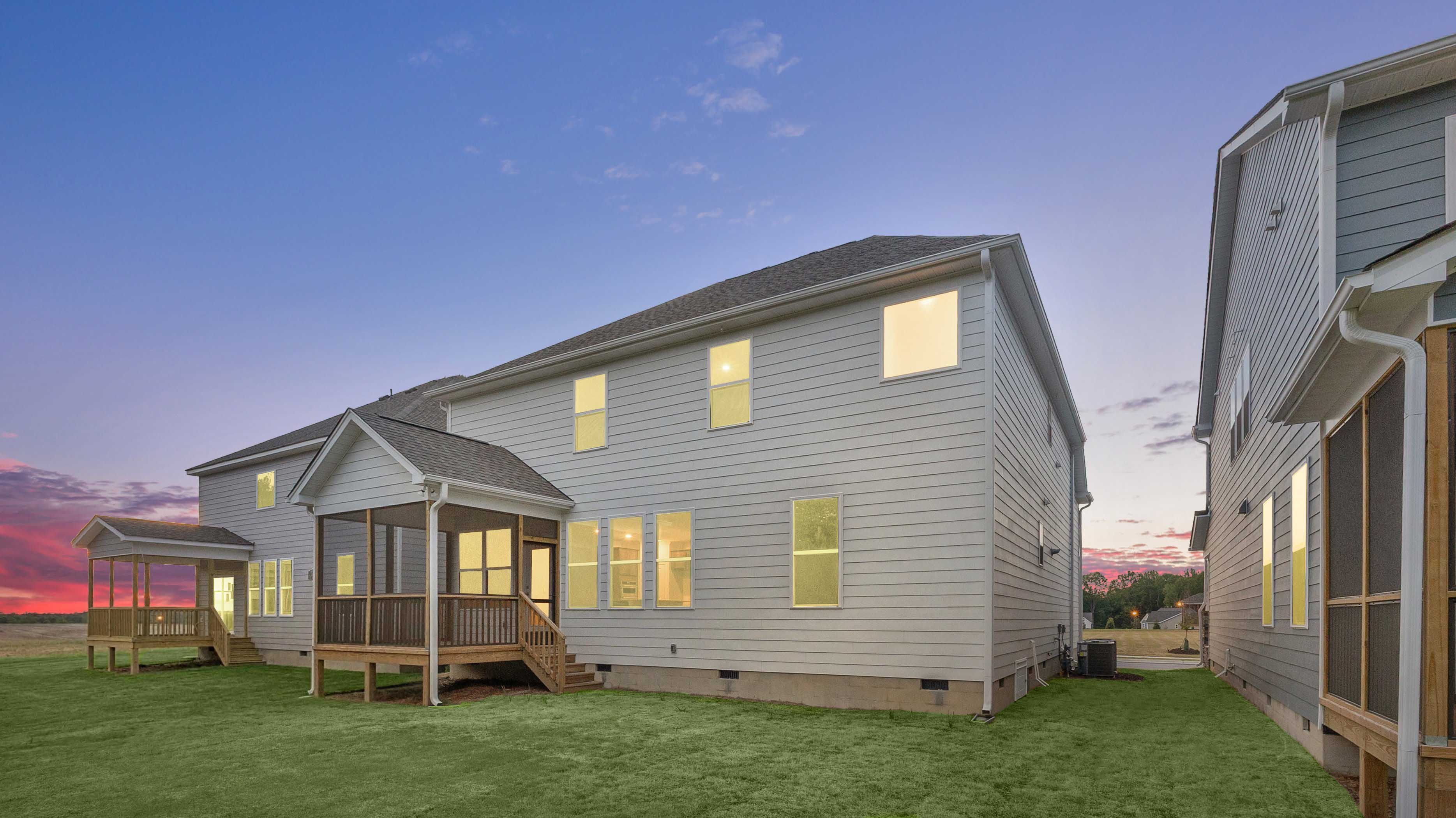 fleetwood backyard with covered and screened deck at twilight