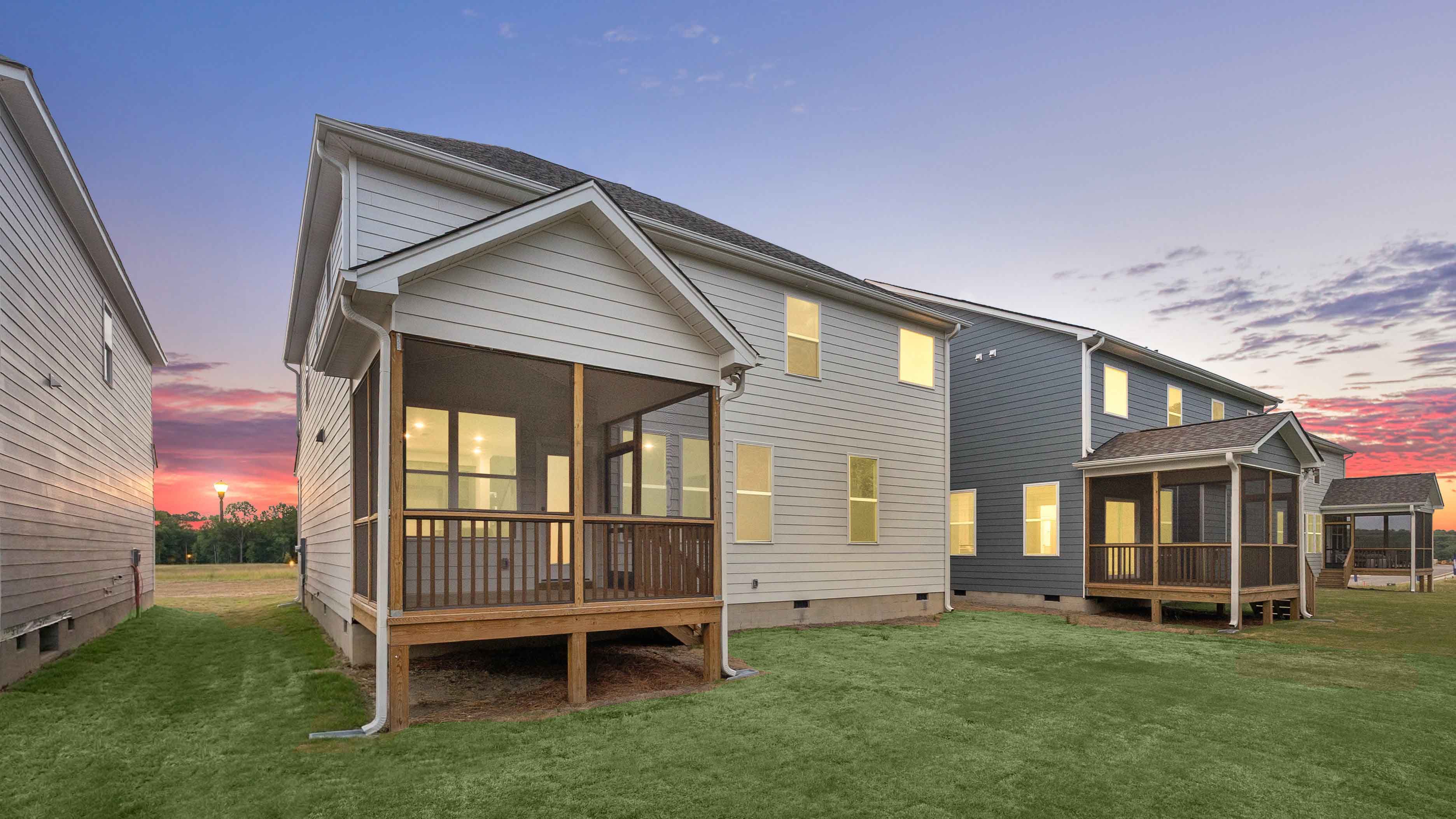 fleetwood backyard with covered and screened deck at twilight