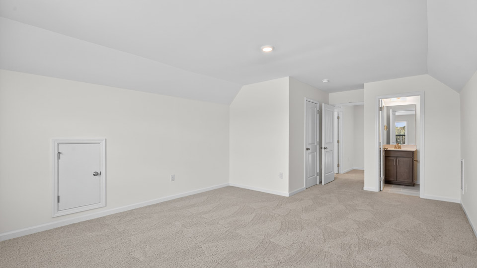 bonus room with vaulted ceiling and carpet flooring