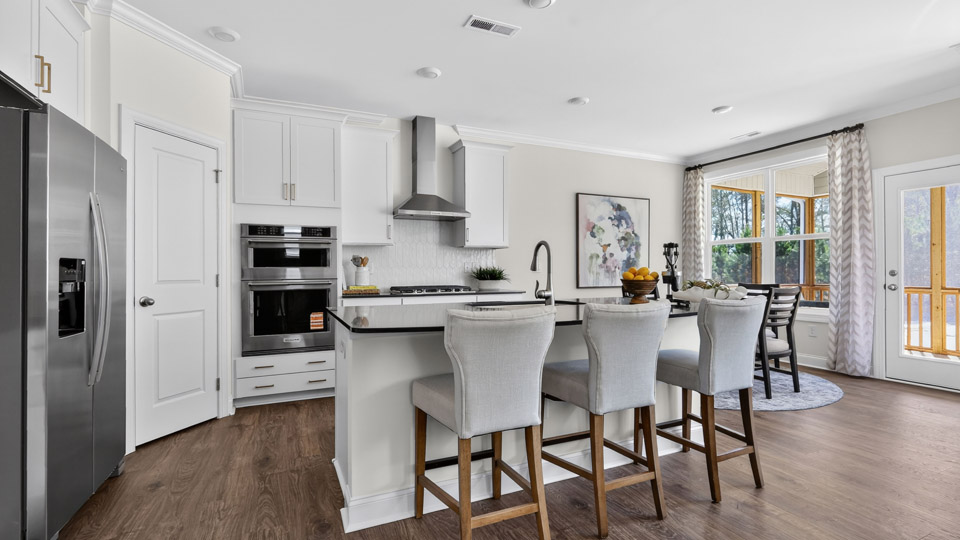 kitchen with large island quartz countertops and white cabinets