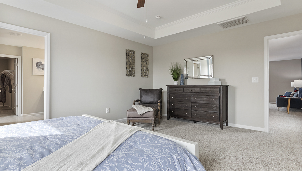 Primary bedroom with carpet flooring