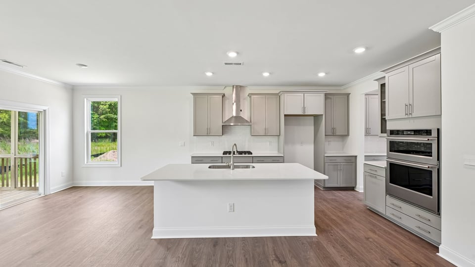 kitchen with island quartz countertops and stainless steel appliances