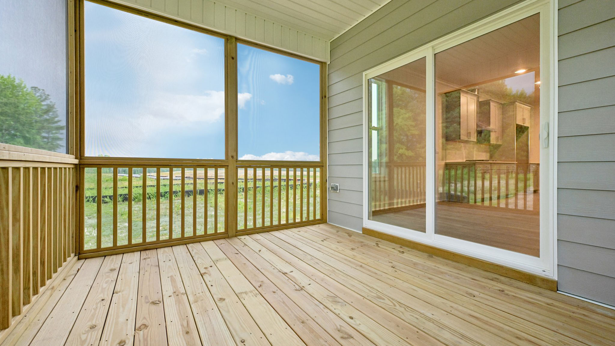 covered and screened in back porch with sliding glass doors
