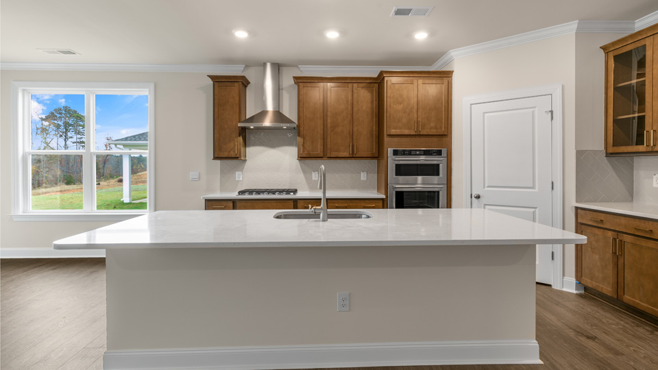 Hartwell Kitchen with Brown cabinets and quartz countertops