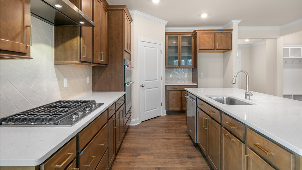 Hartwell Kitchen with Brown cabinets and quartz countertops