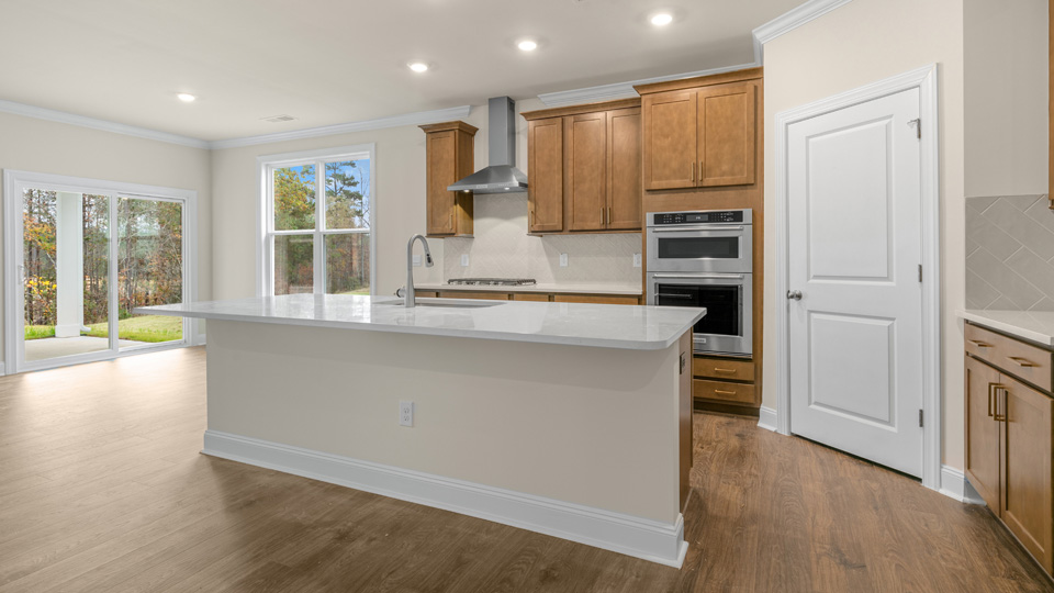 Kitchen with island quartz countertops and brown cabinets