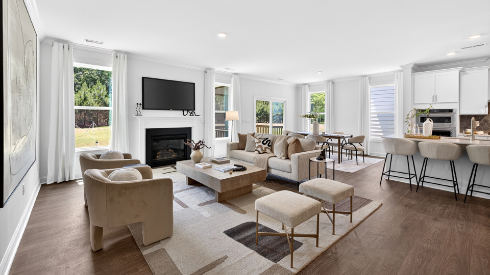 open concept living space with large windows, fireplace