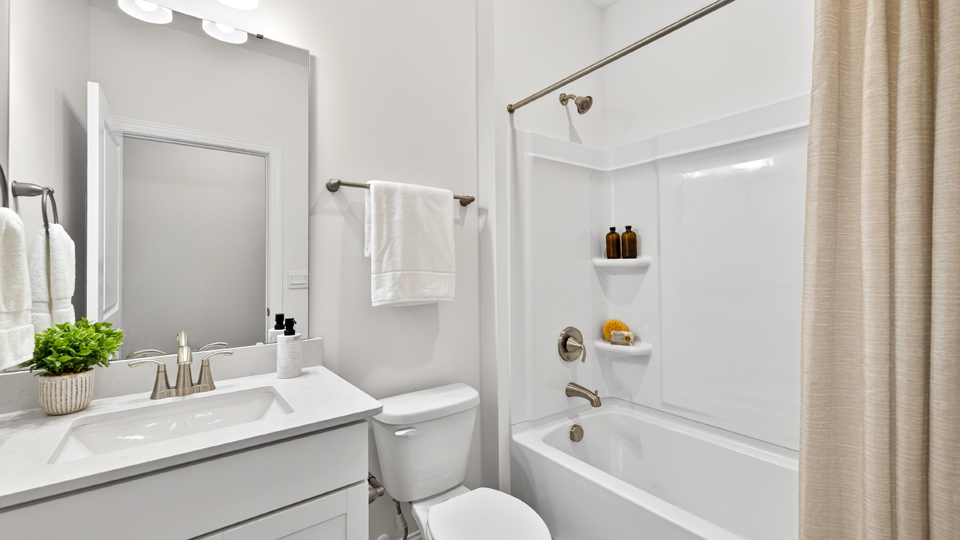 secondary bathroom with shower tub combo and single vanity sink