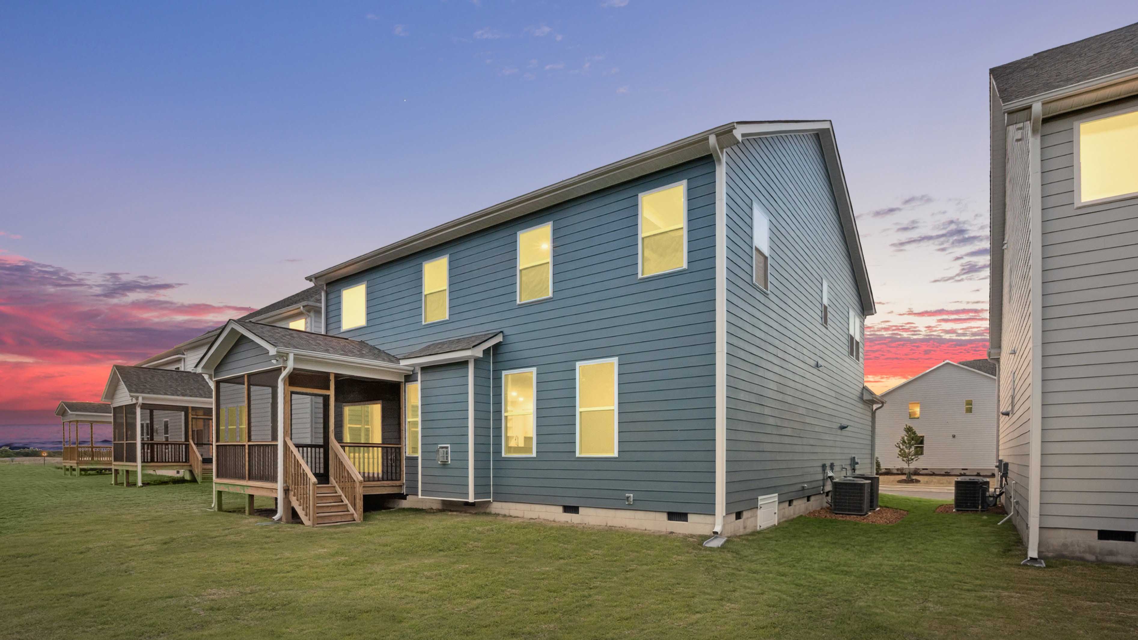 backyard with covered and screened back deck twilight photo